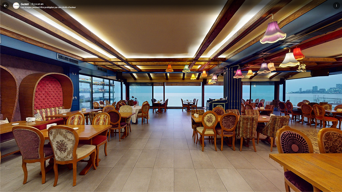 Elegant dining room at Les Tziganes with sea view